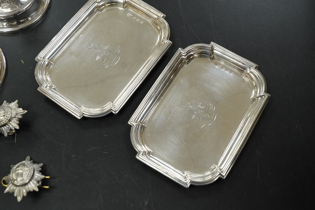 A pair of late Victorian Regimental silver menu holders (Royal Sussex Regiment), a pair of ashtrays and two pairs of uniform pips first height 5cm., weight approx. 7.83ozt